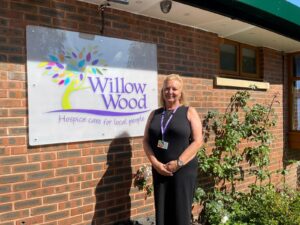 CEO Karen Houlston outside the entrance to Willow Wood Hospice